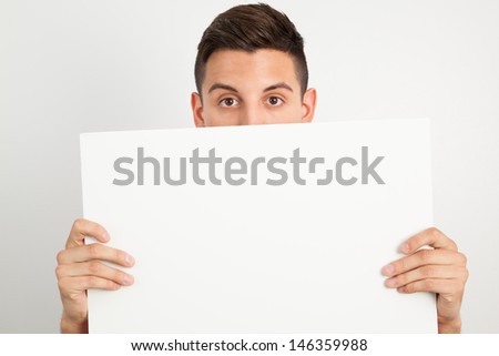 Young and handsome guy posing over white background