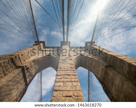 Looking Up one of the Brooklyn Bridge Towers With Sun Flare on the side