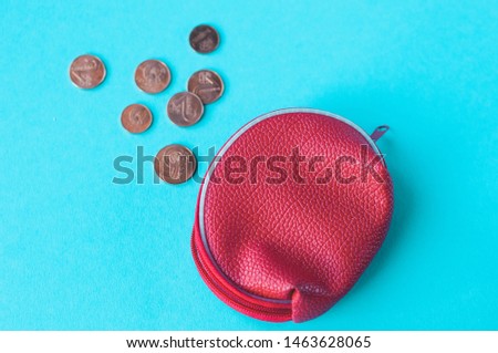 red purse coin on blue background. Top view