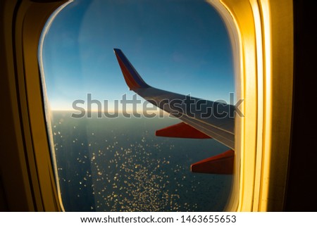 Airplane Wing with Window Frame Royalty-Free Stock Photo #1463655653