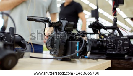 Behind the scenes of video production or video shooting. The concept of production of video content for TV, blog, shows, movies. Cameras prepared for video filming