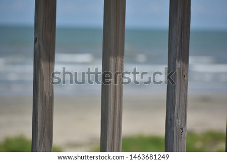 view of the ocean through deck wood