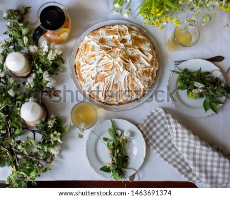 lemon meringue pie and tea at a dining table for two people