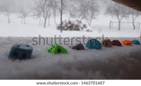 Colored Snow Dices with an winter forrest background