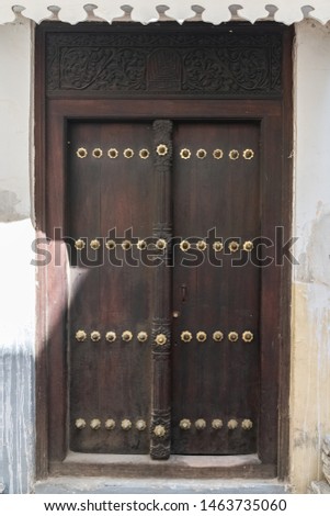 Old wooden door in Stone Town in Zanzibar island, in the historic center
