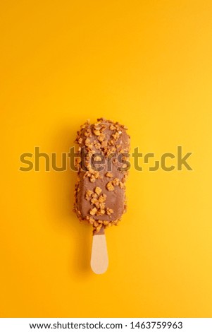 chocolate ice cream popsicle on yellow background