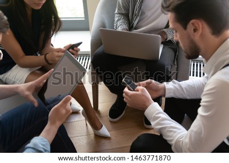 Business people group sitting in circle using smartphones tablet laptop, men and women office team working online on electronic devices holding gadgets, technology addiction concept, close up view Royalty-Free Stock Photo #1463771870