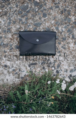 black leather bag on stone slab