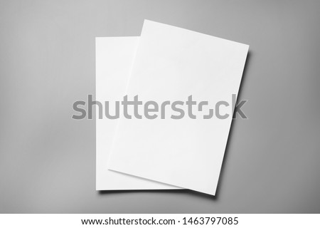 Blank paper sheets for brochure on grey background, top view. Mock up Royalty-Free Stock Photo #1463797085