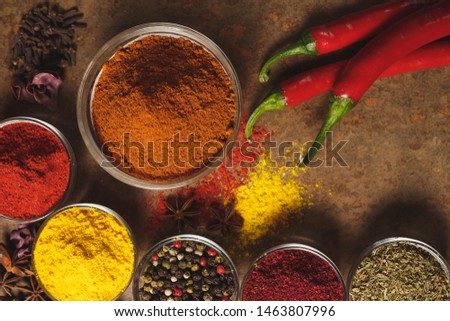 Red hot chili peppers. Place for text. Different types of Spices in a bowl on a stone background. The view from the top.