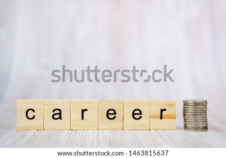 Wooden cube block with word career and coins on the stack. Business career planning growth to success concept
