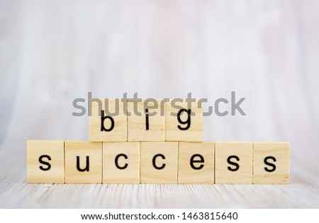 Big success word from wooden blocks on desk. Concept of successful in business