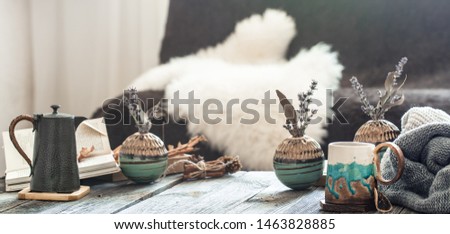 Autumn - winter still Life in a homely atmosphere with decorative items in the living room . With a hot drink on a wooden table. Royalty-Free Stock Photo #1463828885