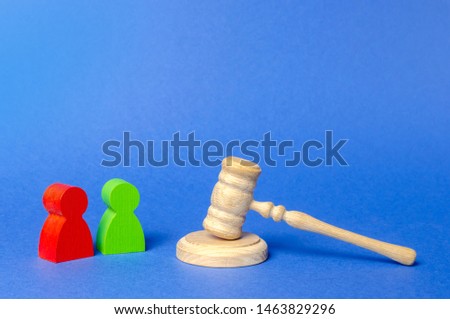 Two figures of people opponents stand near the judge's gavel. The judicial system. Court case, settling disputes. Legal advice, lawyer services. Conflict resolution in court, claimant and respondent. Royalty-Free Stock Photo #1463829296