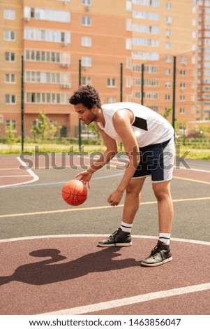 Young basketball player practicing exercise with ball