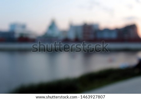 Blurred background. Evening city embankment riverbank.