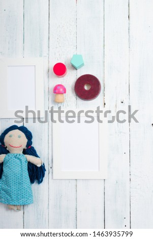 white empty picture frame illustration copy space, homemade doll, wooden background