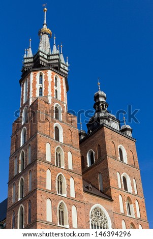 two towers of St. Mary's Basilica on main  market sguare  in cracow in poland on blue sky background