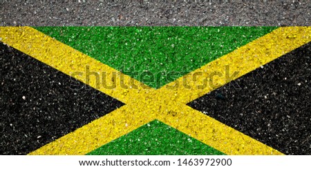 National flag of Jamaica on a stone background.The concept of national pride and symbol of the country.