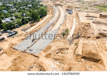 development of city suburb area. construction of new asphalt road. aerial view