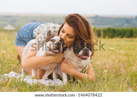 Frame with a beautiful girl with a beautiful dogs outdoor on green grass. stock photo