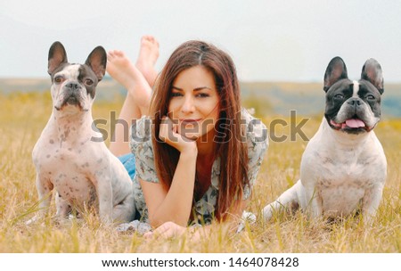 Frame with a beautiful girl with a beautiful dogs outdoor on green grass. stock photo
