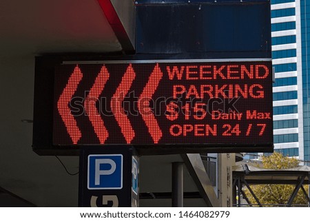 View of weekend parking sign with price