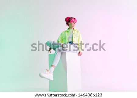 woman sitting on neon retro style cube