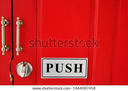 Push sign on door wood  red color.