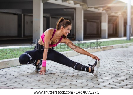 Healthy sports lifestyle. Athletic young woman in sports dress doing fitness exercise. Fitness woman on stadium.