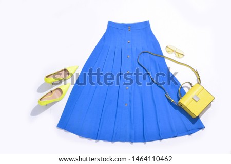Stylish blue skirt with yellow high hell shoes ,yellow sunglasses isolated on white background
