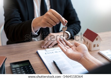Real Estate broker or sale agent giving consultation to customer about buying house sign agreement document contract. Home loan 