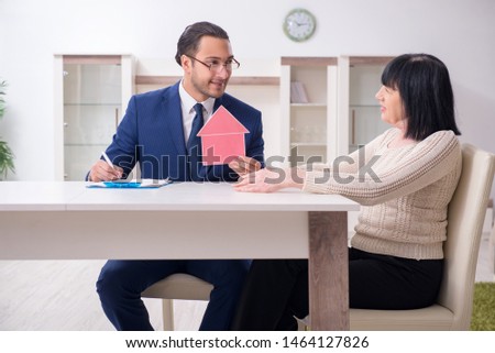 Male real estate agent and female client in the apartment 