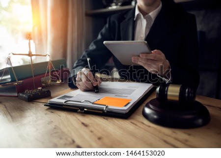 Justice and law concept. Female judge at a courtroom, working with document and laptop on table in modern office, Interface icon.