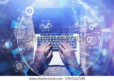 Businessman typing on laptop with double exposure of global business interface. Concept of internet and hi tech. Toned image