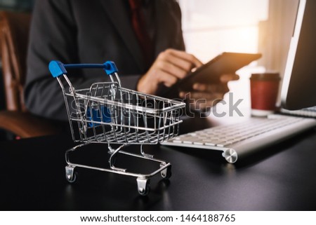 Cart Online Shopping concept. businessman hand using smart phone, tablet payments and holding credit card online shopping, omni channel, computer virtual icons 