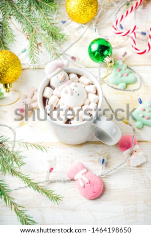 Creative idea for christmas drink, delicious hot chocolate with funny marshmallow snowman, christmas tree, rain dear, santa, on home background with xmas decoration copy space top view