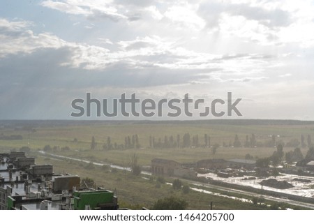 Aerial view of city landscape during rain in sunny cloudy weather