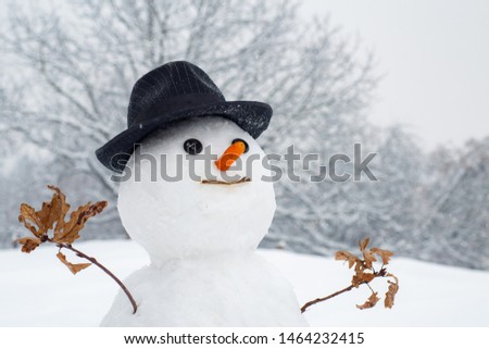 Snowman with light star in Christmas day. Snow man in winter hat. Funny snowmen. Making snowman and winter fun. Snowman gentleman in winter hat