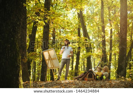 Hobby concept. Painting in nature. Start new picture. Beauty of nature. Bearded man woman and cute son relaxing autumn nature. Drawing from life. Painter artist with family relaxing in forest.