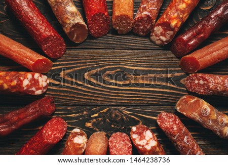 Different types of sausages and meat products on a wooden Board.