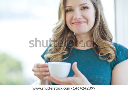 Woman drinking coffee. Beautiful woman in a cafe.