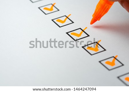 Orange marking on checklist box with pen, Checklist concept Royalty-Free Stock Photo #1464247094