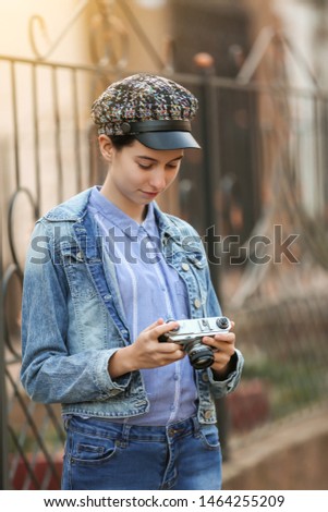 Young girl with photo camera outdoors