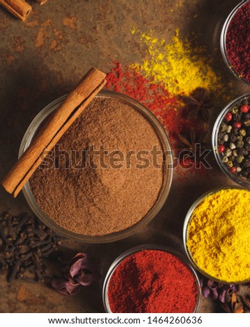Ground Cinnamon. Place for text. Different types of Spices in a bowl on a stone background. The view from the top.