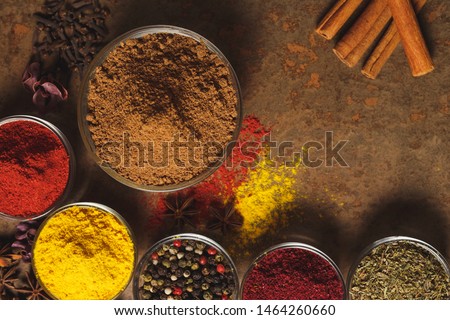 Nutmeg crushed. Place for text. Different types of Spices in a bowl on a stone background. The view from the top.