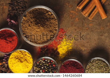 Ground Coriander. Place for text. Different types of Spices in a bowl on a stone background. The view from the top.