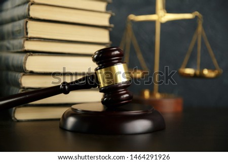 Judge gavel, scales of justice and law books in