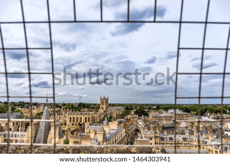 Panorama of the city Cambridge from the observation tower of St.Mary's church. Picture took through bars.