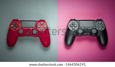 Two gamepad on a colored paper background. Video game. Minimalism, top view.